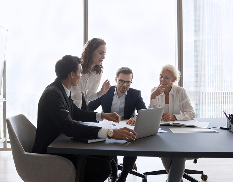 Boardroom of Bell experts looking at SSE cloud security features to keep users and businesses protected and secure from threats.  