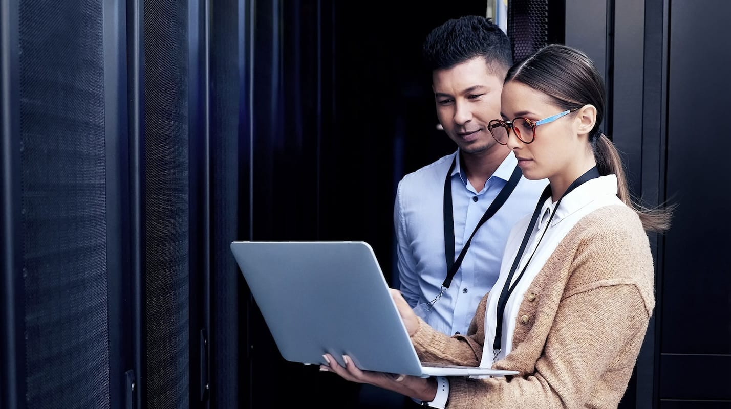 Professional cybersecurity service team analyzing client data on desktop in modern office, collaborating to develop strategic risk management and incident response plans