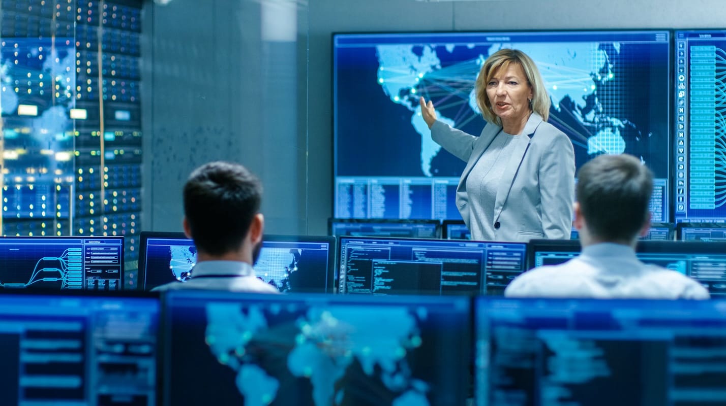 Professional cybersecurity service team analyzing client data on desktop in modern office, collaborating to develop strategic risk management and incident response plans