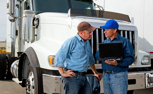 Employees using Bell's asset tracking solution to review the logistics of assets to be shipped.